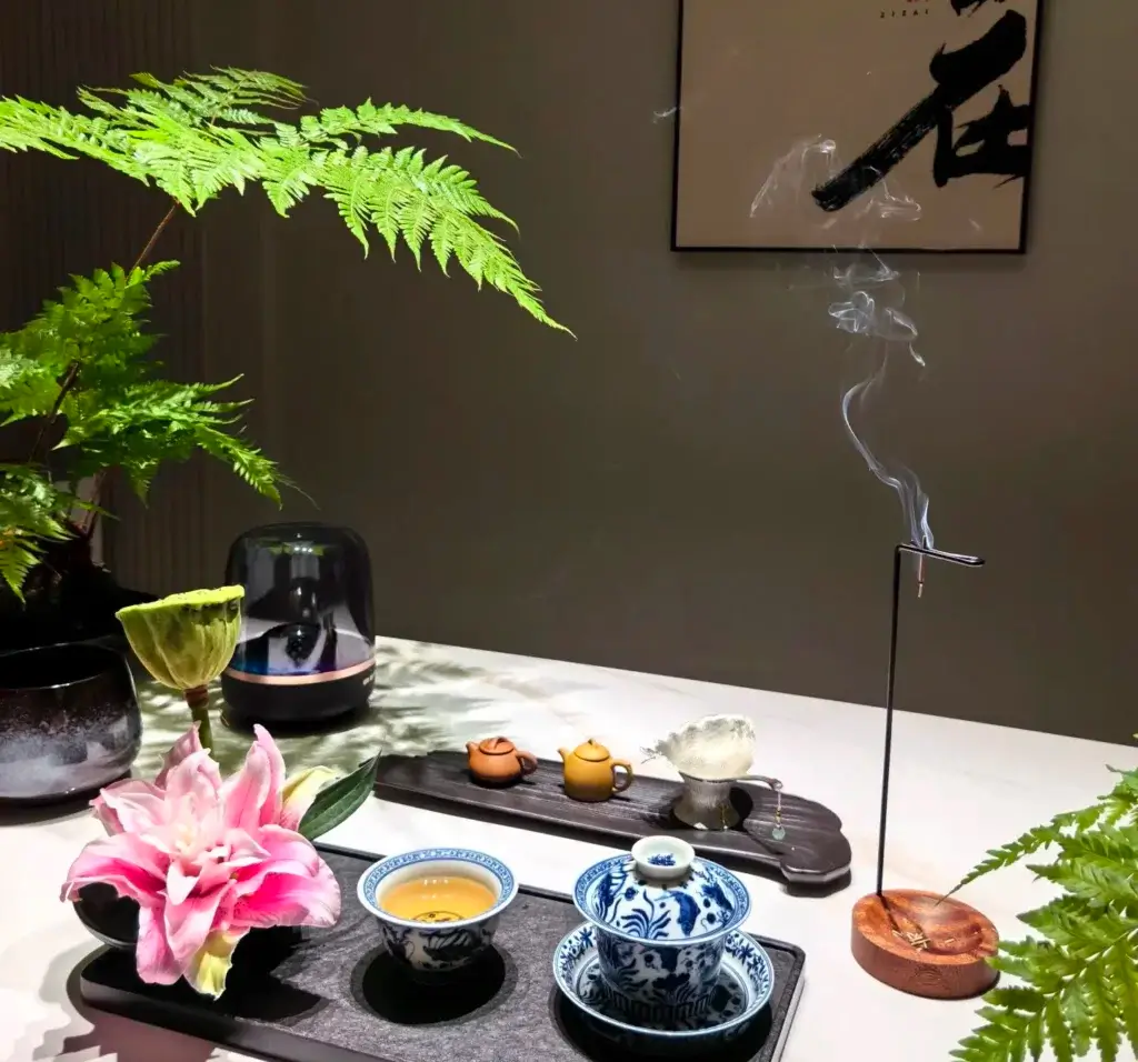 Porcelain tea set with incense and flowers