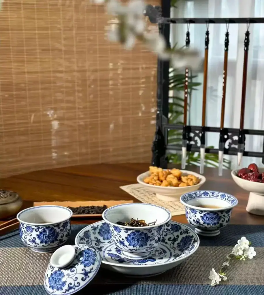 Elegant blue and white porcelain tea set arranged on a modern tea table, blending traditional Chinese craft with serene daily lifestyle