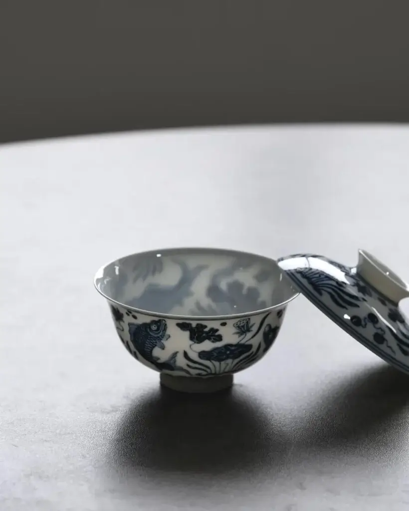 Close-up blue and white Chinese porcelain teacups with hand-painted fish patterns