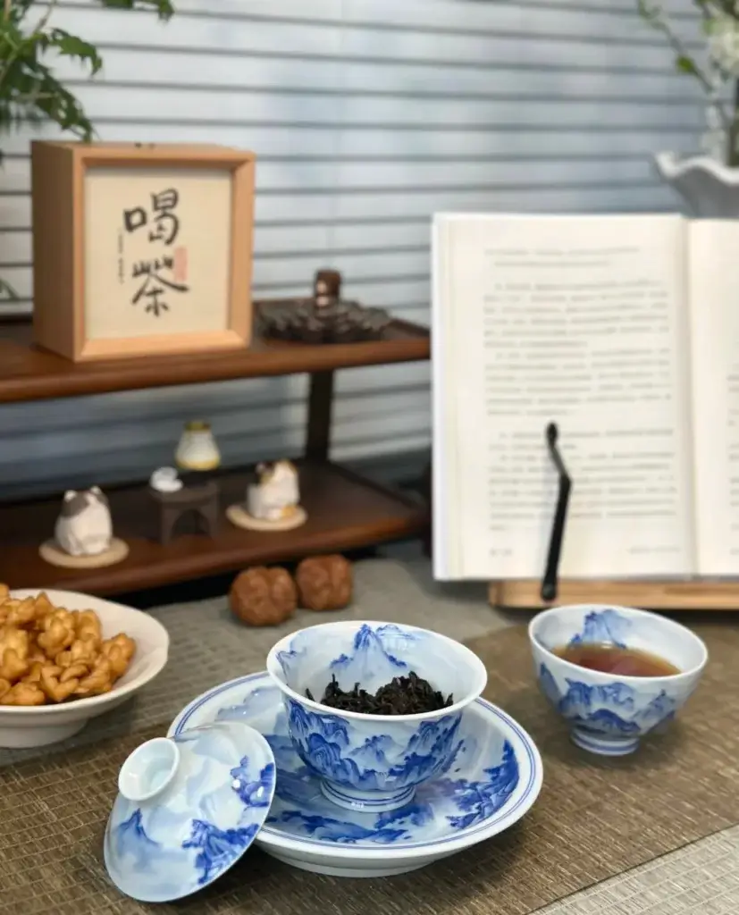 Handmade Chinese porcelain teacup with blue-and-white mountain landscape pattern in traditional tea ceremony
