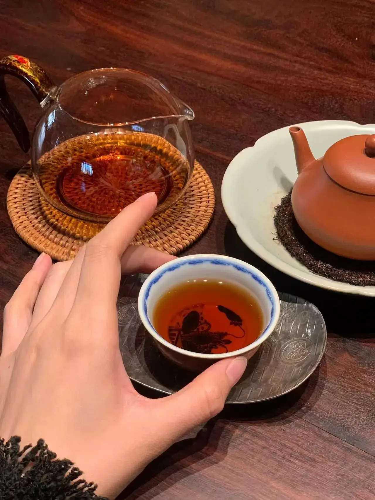 Hands holding a warm Chinese porcelain teacup for calm and mindfulness