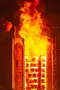 Wood-fired kiln firing handmade Chinese porcelain teacup with glowing fiery light